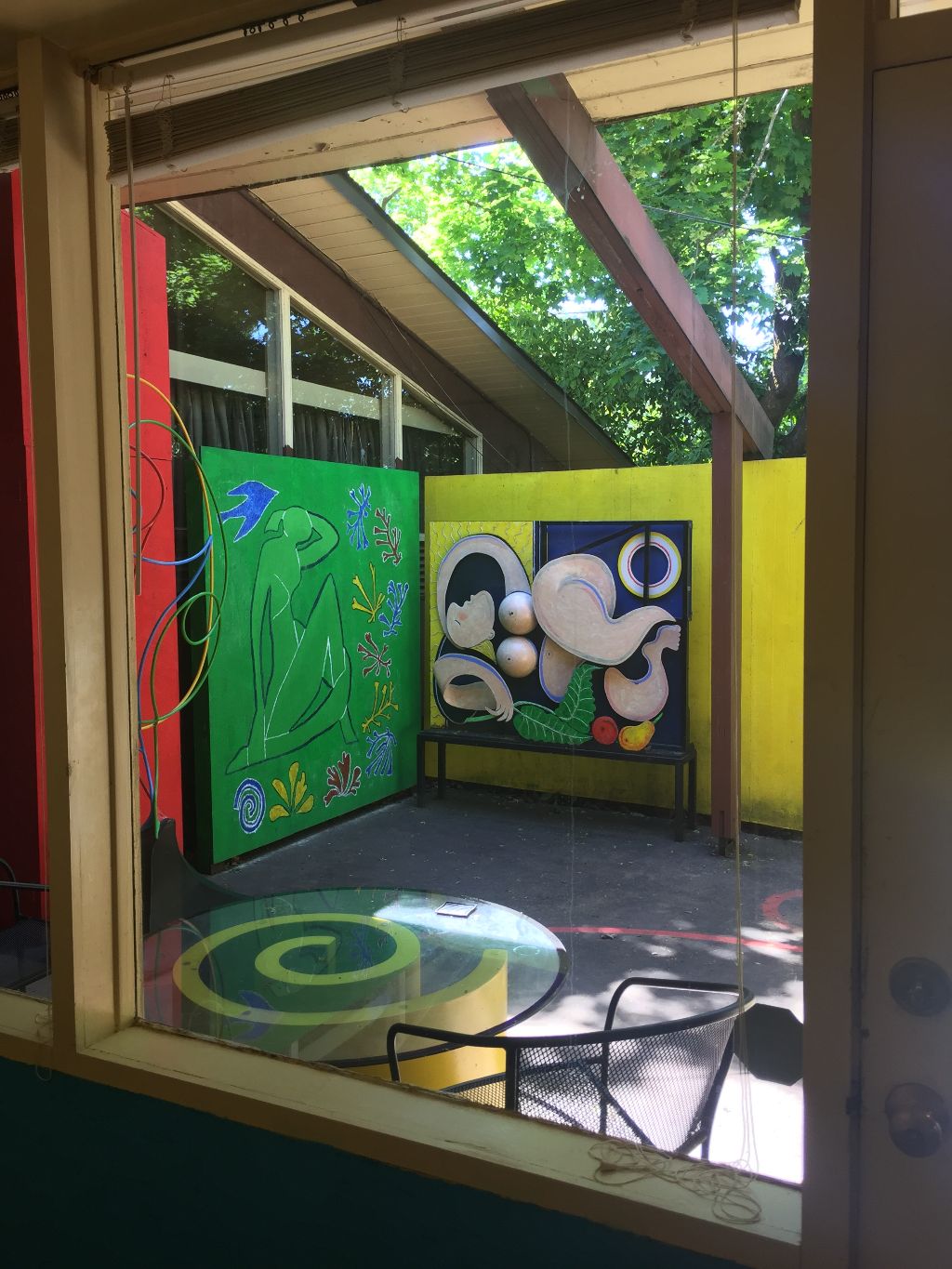10b. Small patio art viewed from the interior. The painting on the 7' x 7' green panel is based on Matisse's cutouts. I call it "Matisse on nature".