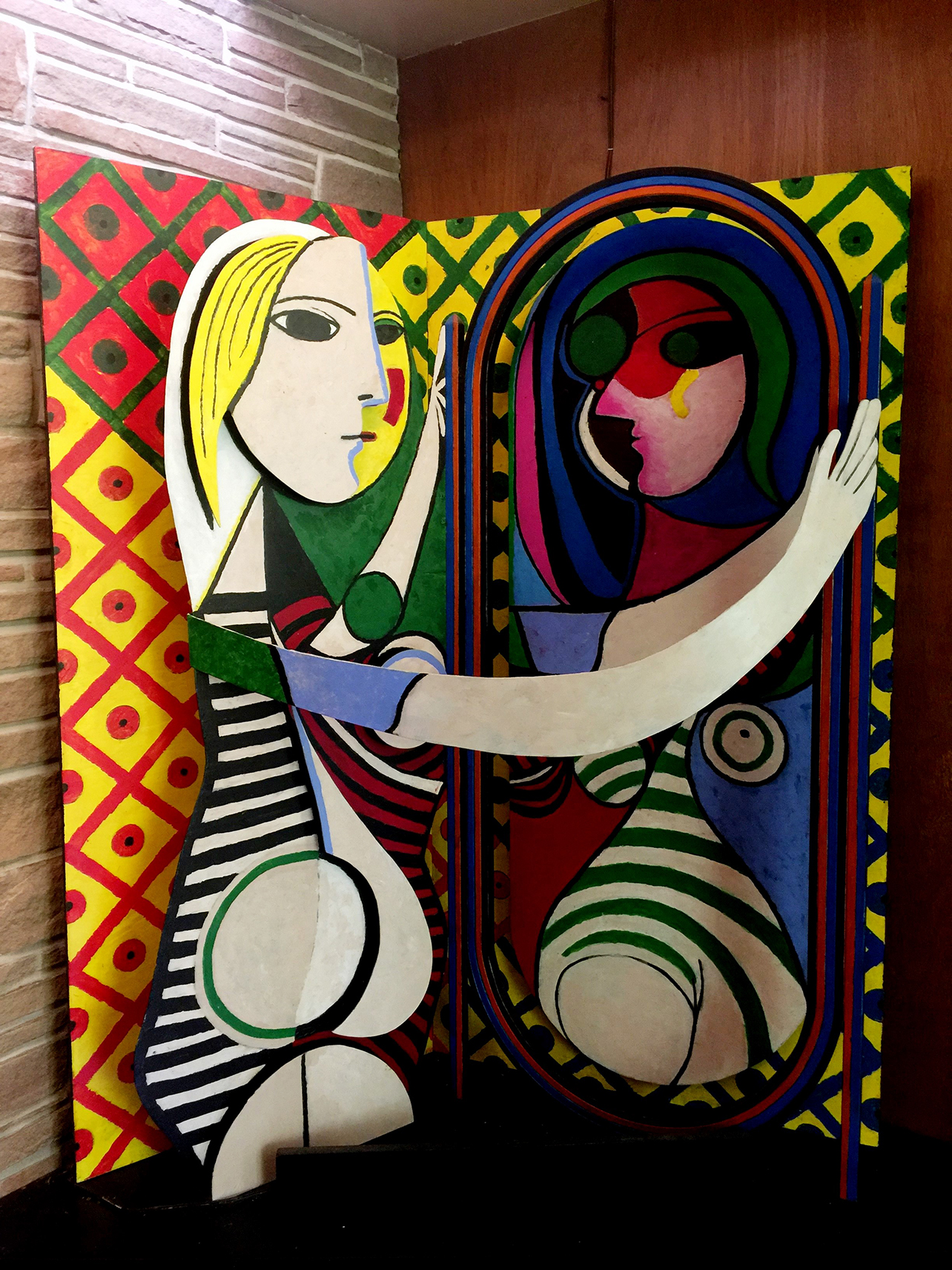 16a. Woman before a mirror. 4’ x 2’ x 5’. The sculpture rests on a platform, which stands 18 inches from the floor. Not shown in the picture is a triangular steel bench, which is part of the sculpture.